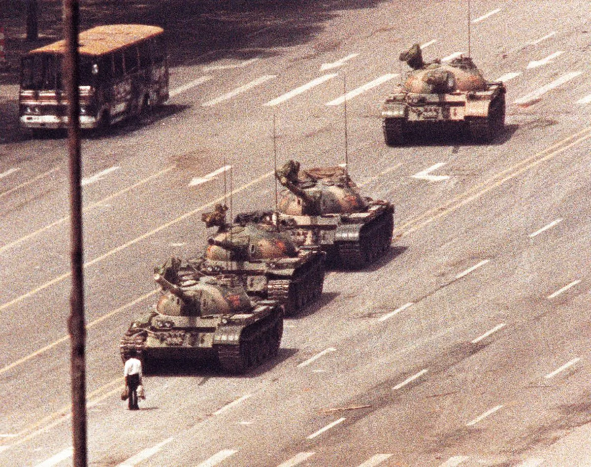 A man stands in front of a convoy of tanks in the Avenue of Eternal Peace in Beijing on June 5, 1989. (Arthur Tsang/Reuters)
