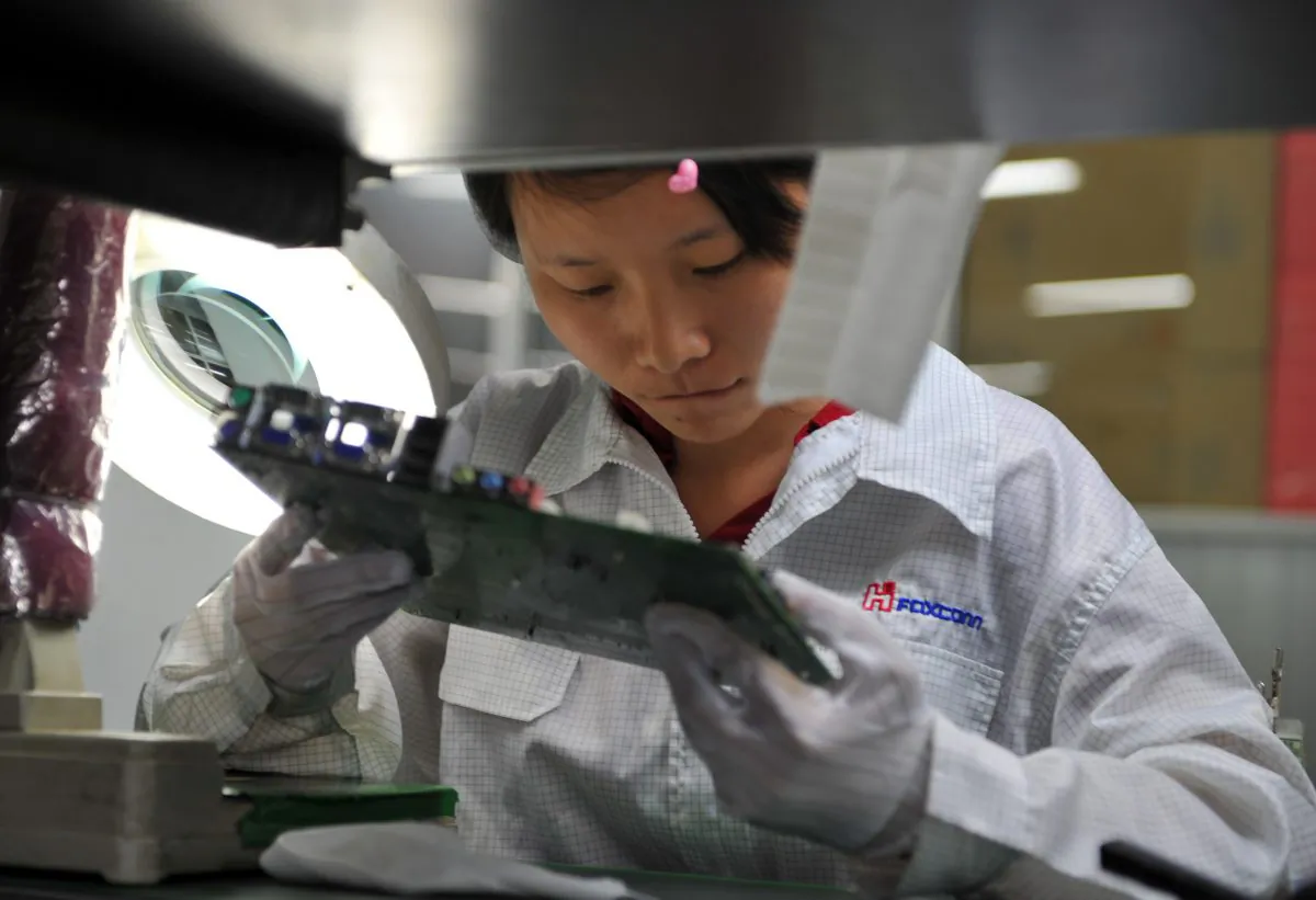 A worker inspects motherboards on a factory line at the Foxconn plant in Shenzhen on May 26, 2010. (VOISHMEL/AFP/Getty Images)