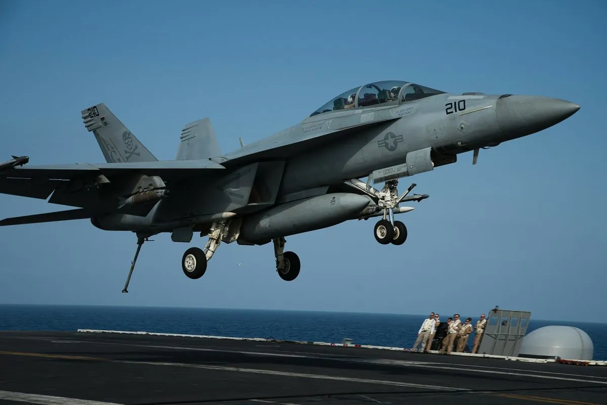 An F/A-18 fighter jet lands on the deck of the USS Abraham Lincoln aircraft carrier in the Arabian Sea on June 3, 2019. AP Photo/Jon Gambrell