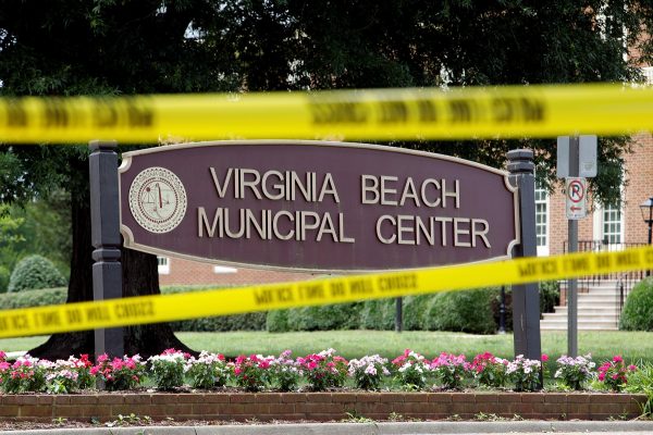 Police tape frames a sign at one of the entrances to the municipal government complex