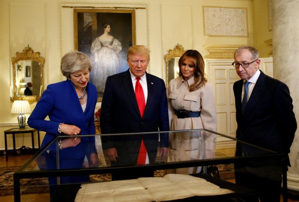 President Donald Trump and First Lady Melania Trump review items with Britain's Prime Minister Theresa May and her husband Philip