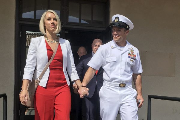 Navy Special Operations Chief Edward Gallagher, left, hugs his wife,