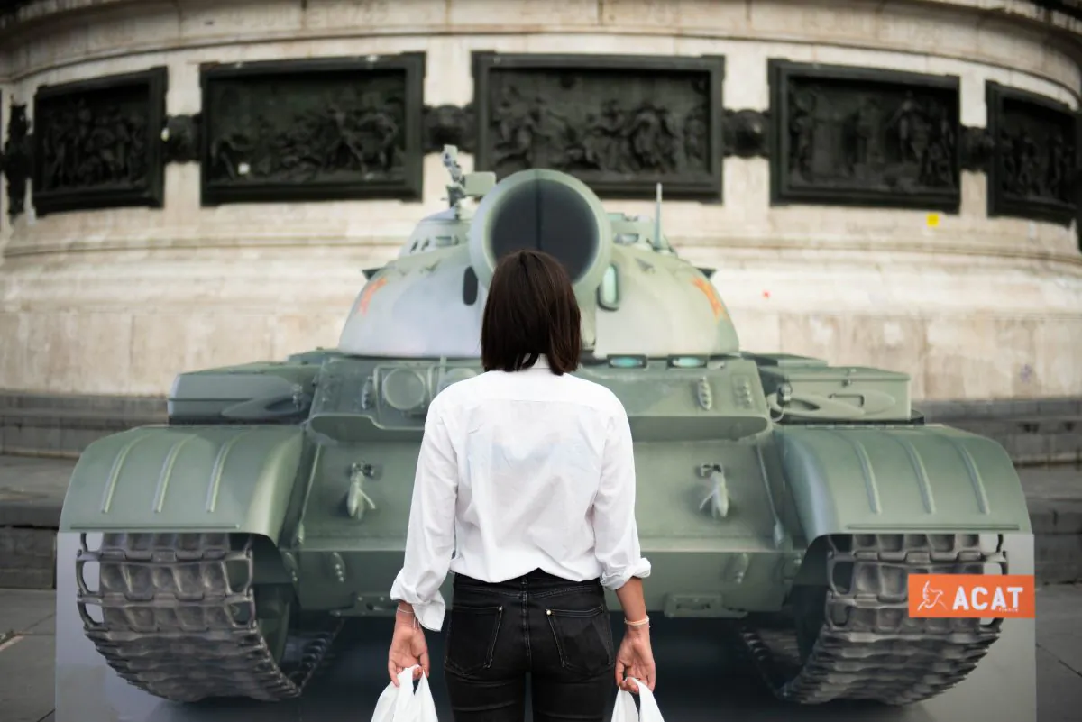An activist stands in front of an image of a tank in Paris, France, replicating the scene where an unknown Chinese man, known as the “Tank Man,” stood in front of a column of tanks during the 1989 Tiananmen Square protests in Beijing, to mark the 30th anniversary of the Tiananmen Square massacre on June 4, 2019. (Stringer/AFP/Getty Images)
