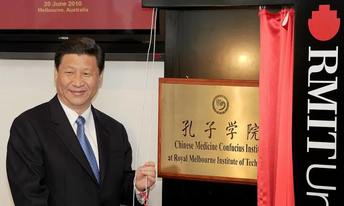 China's vice chair Xi Jinping unveils a plaque at the opening of Australia's first Chinese Medicine Confucius Institute at the RMIT University in Melbourne on June 20, 2010. (William West/AFP/Getty Images)