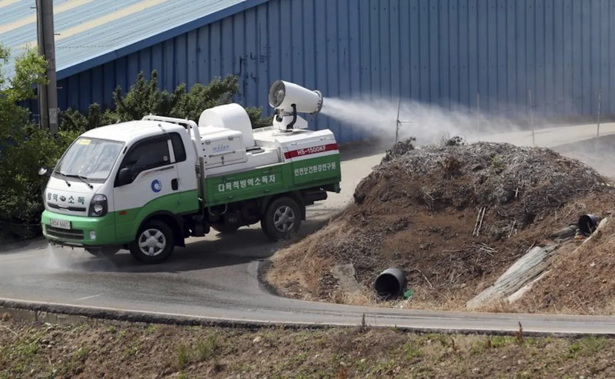 Health officials spray disinfectant solution as a precaution against African swine fever near a pig farm in Incheon, South Korea on June 3, 2019. South Korea is concerned North Korea is ignoring its calls for joint efforts to stem the spread of highly contagious African swine fever following an outbreak in North Korea. (Yun Tae-hyun/Yonhap via AP)