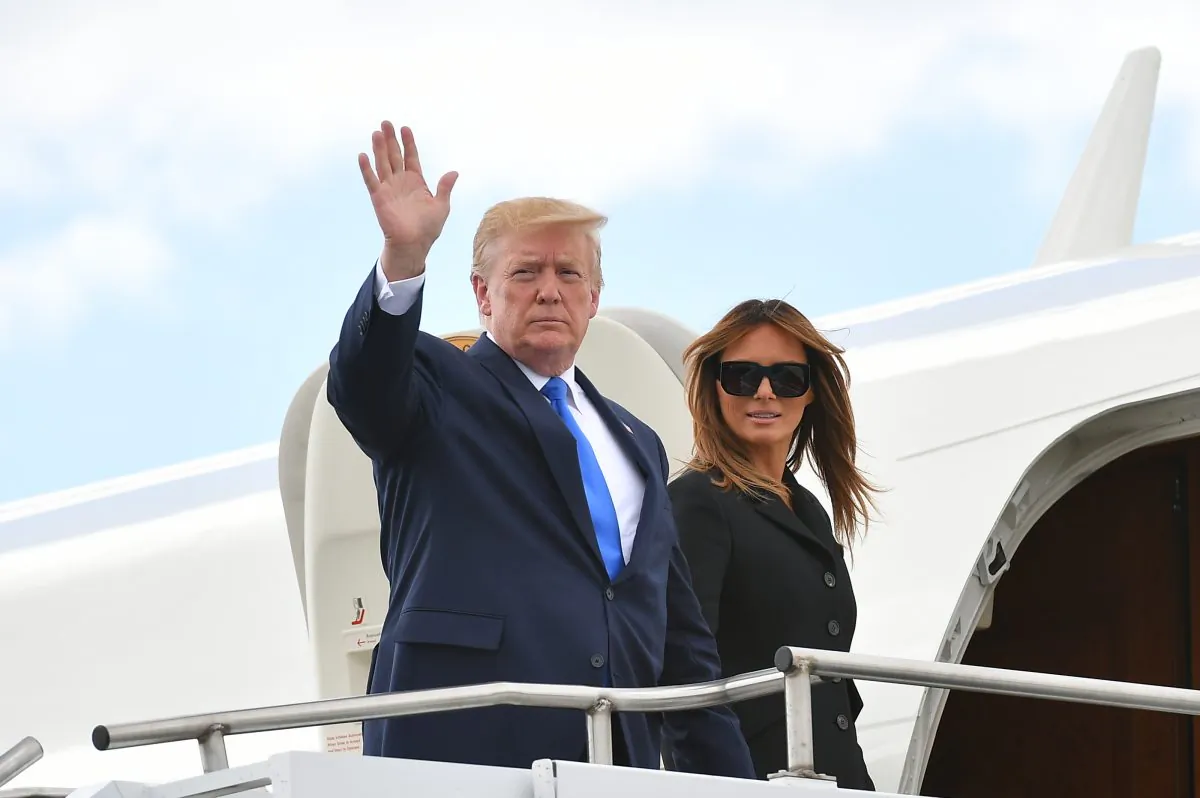 President Donald Trump (L) and US First Lady Melania Trump board Air Force One before departing from the Caen-Carpiquet Airport in Carpiquet, Normandy, northwestern France, on June 6, 2019, after attending D-Day commemorations marking the 75th anniversary of the World War II Allied landings in Normandy.         (Mandel Ngan/AFP/Getty Images)