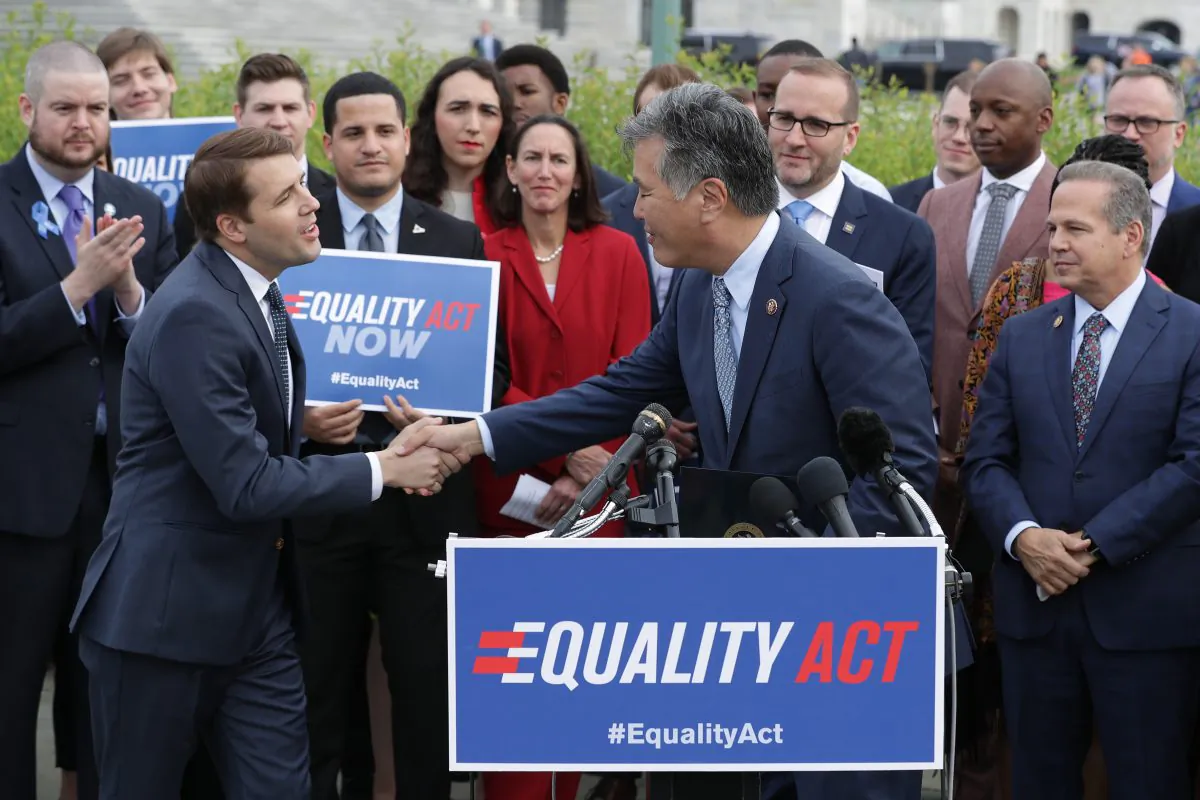 Rep. Mark Takano (D-Calif.) (C) welcomes Rep. Chris Pappas (D-N.H.) to the lectern during a rally and news conference with Rep. David Cicilline (D-R.I.) (R) and leaders from LGBTQ advocacy organizations before the House votes on the Equality Act in Washington, D.C., on May 17, 2019. The openly gay politicians and their supporters called on the Republican-controlled Senate to pass the Equality Act, which would modify existing civil rights law to extend anti-discrimination protections to LGBT Americans in employment, education, credit, jury service, federal funding, housing and public accommodations. (Chip Somodevilla/Getty Images)