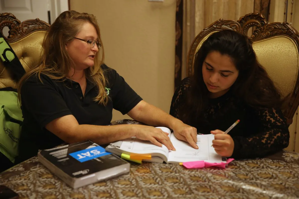 Carol McMullen-Pettit, a Premier Tutor at The Princeton Review, (L) goes over SAT test preparation with 11th grader, Suzane Nazir, on March 6, 2014 in Pembroke Pines, Florida. Joe Raedle/Getty Images