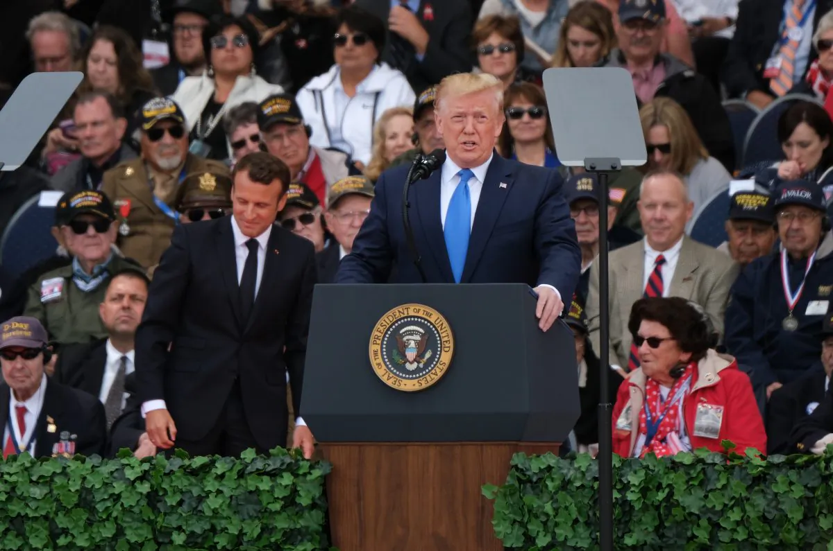 President Donald Trump speaks as French President Emmanuel Macron (C-L)and American Battle of Normandy veterans and family members look on at the main ceremony to mark the 75th anniversary of the World War II Allied D-Day invasion of Normandy at Normandy American Cemetery near Colleville-Sur-Mer, France on June 6, 2019. (Sean Gallup/Getty Images)
