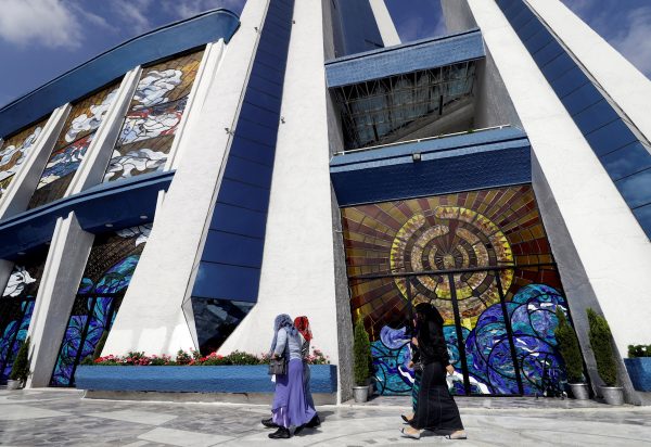 Devotees walk outside a La Luz del Mundo (The Light of the World) church after its leader Naason Joaquin Garcia was arrested in California, in Mexico City