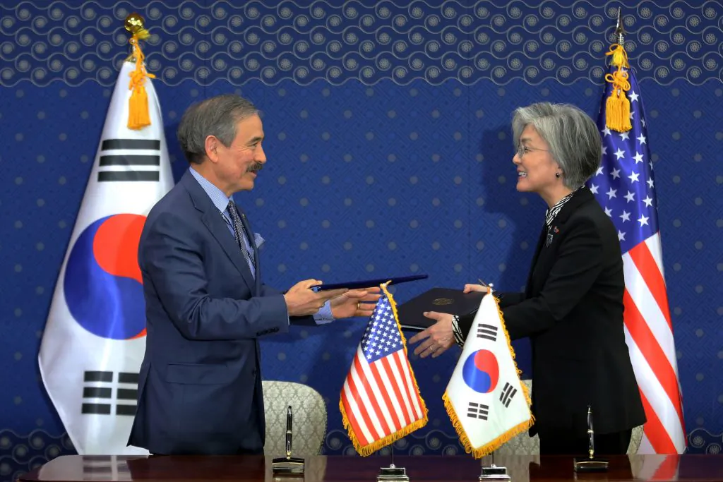 South Korea's Foreign Minister Kang Kyung-wha (R) and US Ambassador to South Korea Harry Harris exchange documents at the Foreign Ministry in Seoul on March 8, 2019. (Ahn Young-joon/AFP/Getty Images)