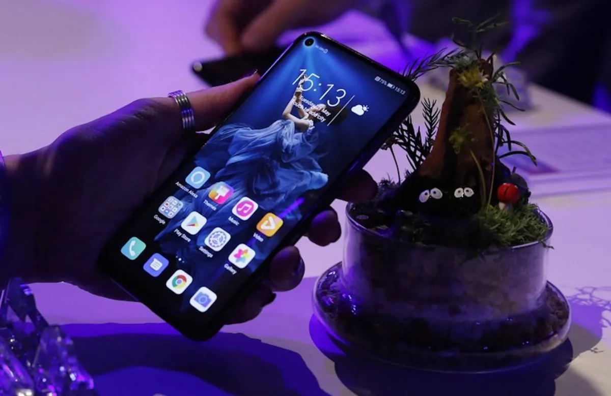 A member of the media tries out new Huawei Honor 20 series of phones following their global launch in London on May 21, 2019. Facebook said on June 7 it suspended providing software for Huawei to put on its devices while it reviews recently introduced U.S. sanctions. (Alastair Grant/AP)