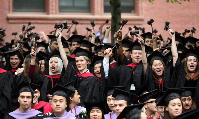 Graduating Harvard University Law School students stand and wave gavels in celebration at commencement ceremonies in Cambridge, Mass. on June 5, 2008. (Robert Spencer/Getty Images)