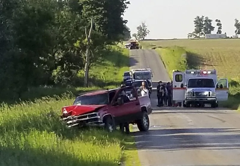 A damaged truck sits on the side of the road after an accident involving a horse-drawn carriage in California Township, Mich., on June 7, 2019.  (Don Reid/The Daily Reporter via AP)