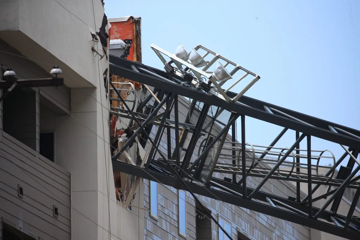 Officials respond to the scene after a crane collapsed into Elan City Lights apartments amid severe thunderstorms in Dallas, Texas on June 9, 2019. (Shaban Athuman/The Dallas Morning News via AP)