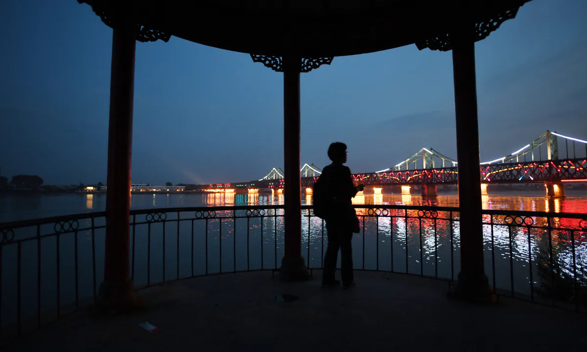 A woman looking at a bridge in China. (Greg Baker/AFP/Getty Images)