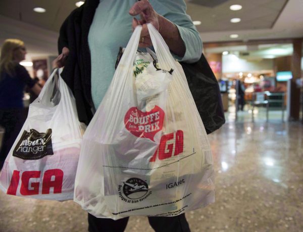 A woman leaves a grocery store on May 15, 2015 in Montreal. (Ryan Remiorz/The Canadian Press)