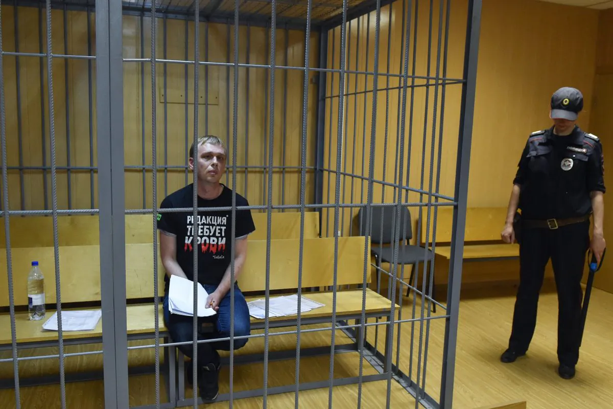 Russian investigative journalist Ivan Golunov, charged with attempted drug-dealing, sits inside a defendants' cage during a hearing at a court in Moscow on June 8, 2019.  VASILY MAXIMOV/AFP/Getty Images