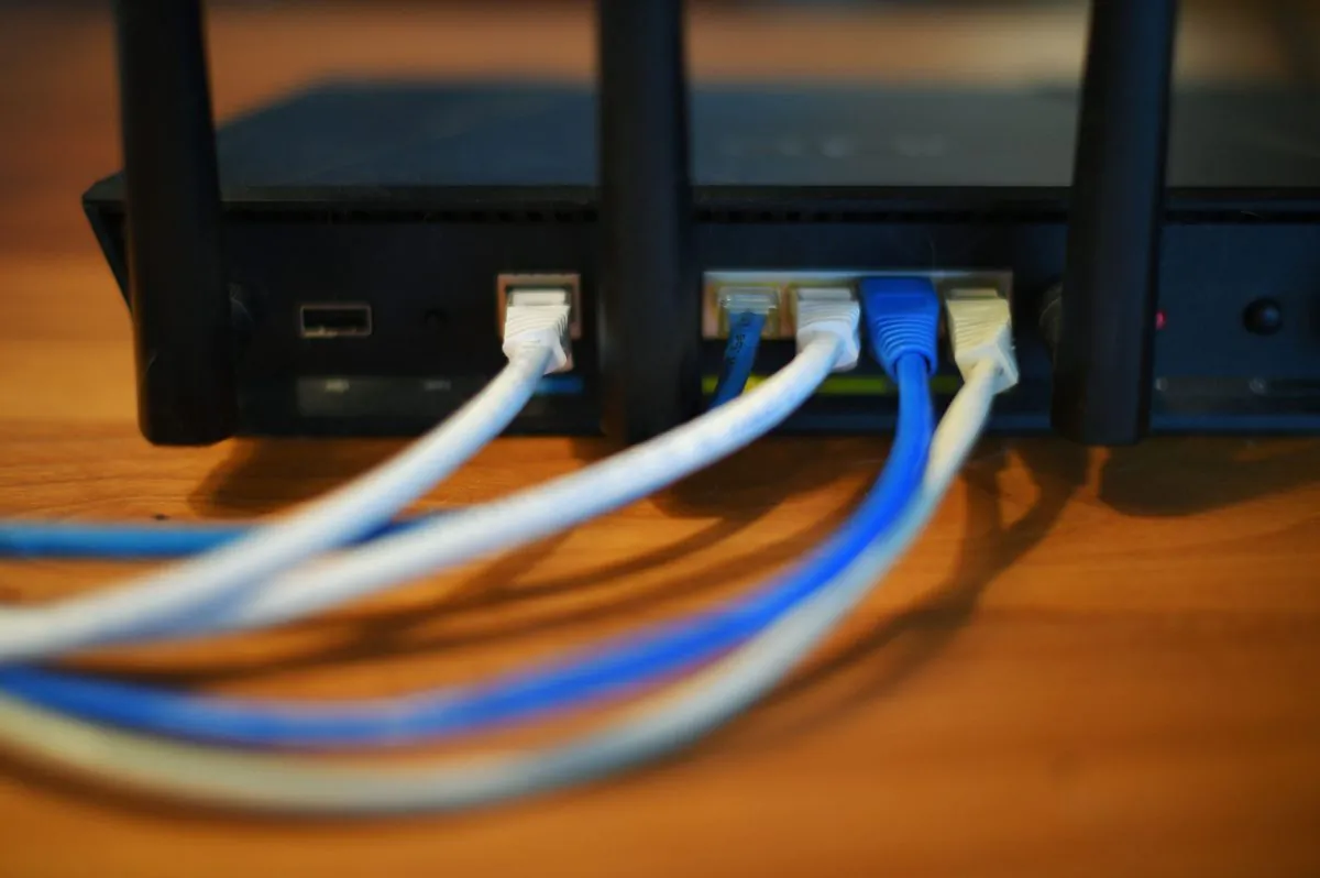 Ethernet cables are seen running from the back of a wireless router in Washington, D.C. on March 21, 2019. (Mandel Ngan/AFP/Getty Images)