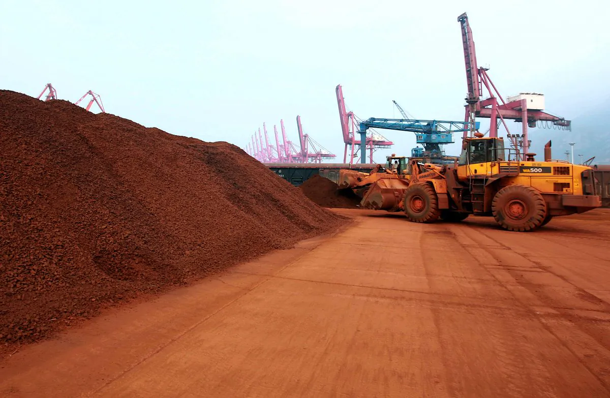 A man driving a front loader shifts soil containing rare earth minerals to be loaded at a port in Lianyungang, east China's Jiangsu province, on Sept. 5, 2010. (STR/AFP/Getty Images)