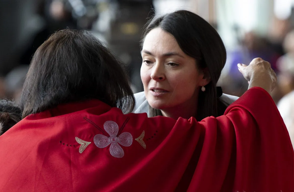 A woman embraces Commissioner Qajaq Robinson during ceremonies marking the release of the final report of the National Inquiry into Missing and Murdered Indigenous Women and Girls (MMIWG) in Gatineau, Que., on June 3, 2019. (THE CANADIAN PRESS/Adrian Wyld)
