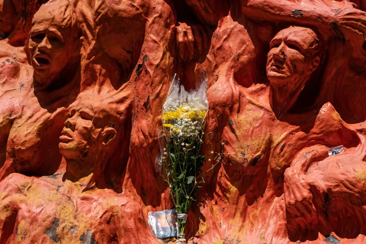 Flowers are placed in front of the 'Pillar of Shame' statue, an art piece dedicated to the victims of the 1989 Beijing Tiananmen Square massacre, at the University of Hong Kong in Hong Kong, China, on June 4, 2019. (Anthony Kwan/Getty Images)