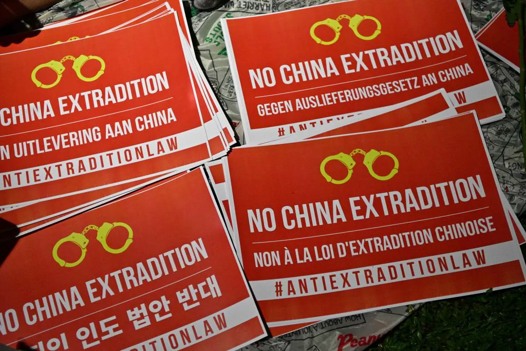 Posters that read No China Extradition are displayed as people gather outside the government headquarters in Hong Kong late on June 11, 2019. (Anthony Wallace/AFP/Getty Images)
