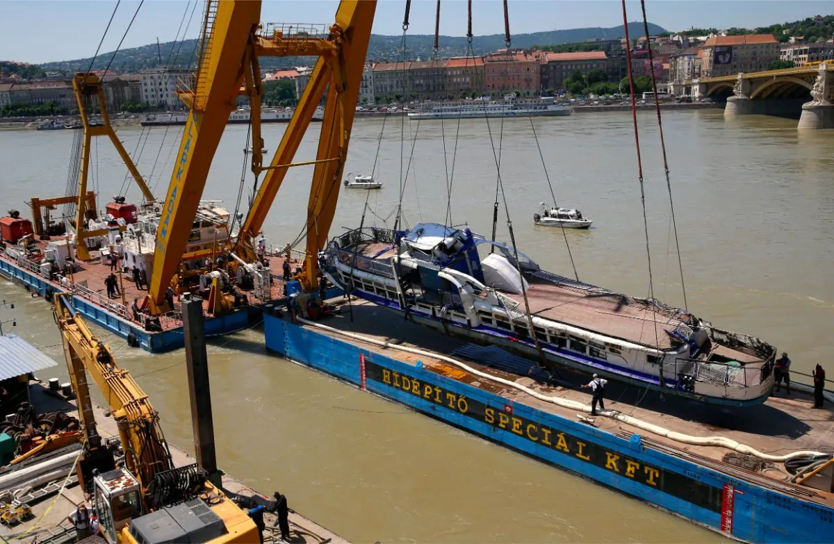 A crane lifts the sightseeing boat out of the Danube river in Budapest, Hungary, on June 11, 2019. (AP Photo/Darko Bandic)