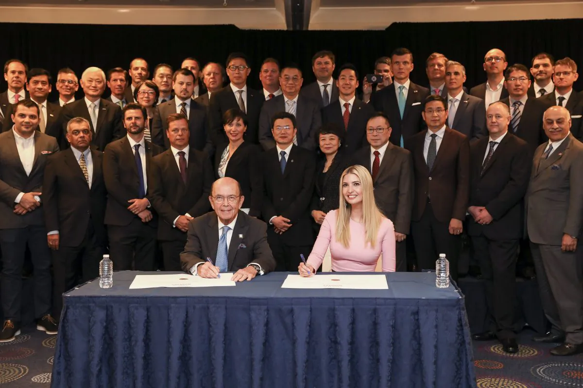 Advisor to the President Ivanka Trump and Secretary of Commerce Wilbur Ross sign the Pledge to America's Workers at the 2019 SelectUSA Investment Summit in Washington on June 12, 2019. (Samira Bouaou/The Epoch Times)