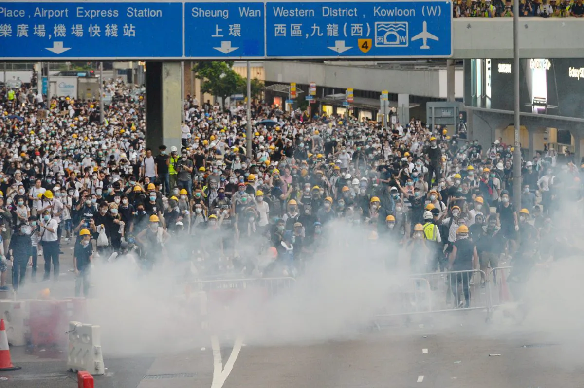 Protestors are shrouded in tear gas during a protest against proposed extradition bill near Hong Kong's Legislative Council on June 12, 2019. (Song Bilong/The Epoch Times)