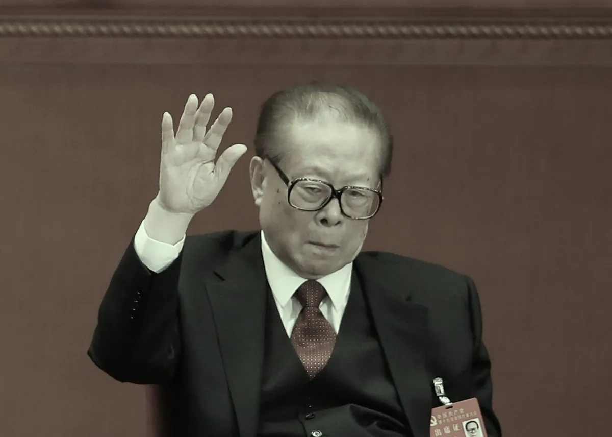 Jiang Zemin, retired general secretary of the Chinese Communist Party, raises his hand at the 19th Party Congress on Oct. 24, 2017 in Beijing. Claims by self-exiled Chinese billionaire Guo Wengui and analysis of stock data suggest that the Jiang family may possess as much as $1 trillion in shadow assets. (Lintao Zhang/Getty Images)