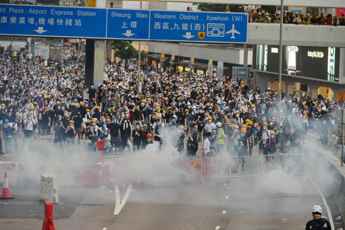 As mass protests intensified, Hong Kong police fired tear gas and rubber bullets at of protesters on June 12, 2019 outside Hong Kong's Legislative Council building. (Bilong Song/The Epoch Times)