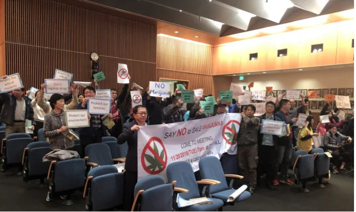 Protesters showed banners against cannabis industry during the city council meeting at Milpitas City Hall in Milpitas, Calif. on Nov. 20, 2018. (Nathan Su/The Epoch Times)