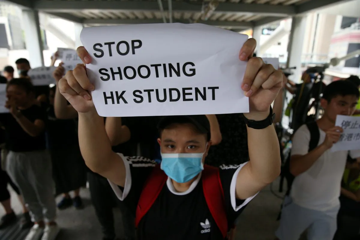 A protester holds a sign following a day of violence over an extradition bill that would allow people to be sent to mainland China for trial, in Hong Kong, on June 13, 2019. (Athit Perawongmetha/Reuters)
