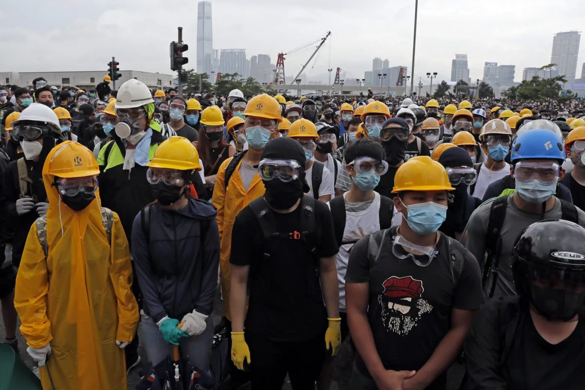 Protestors wear masks and helmets to protect their identities near the Legislative Council in Hong Kong on June 12, 2019. Young Hong Kong residents protesting a proposed extradition law that would allow suspects to be sent to China for trial are seeking to safeguard their identities from potential retaliation by authorities employing mass data collection and sophisticated facial recognition technology. (Kin Cheung/AP)