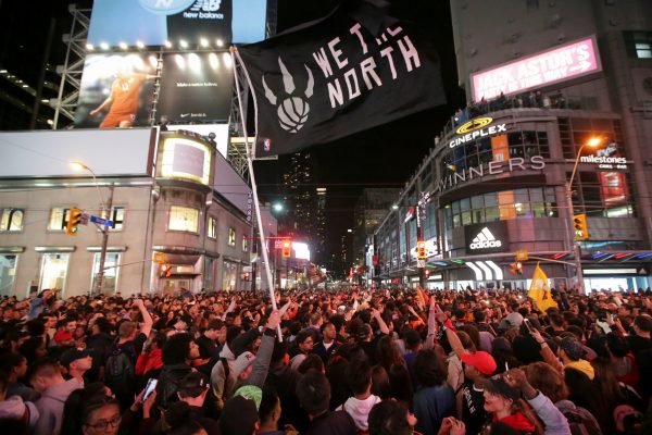 Fans celebrate in the streets of Toronto, Canada after the Toronto Raptors win the NBA Championship in Toronto, Ontario, Canada, June 13, 2019.(Chris Helgren/Reuters)