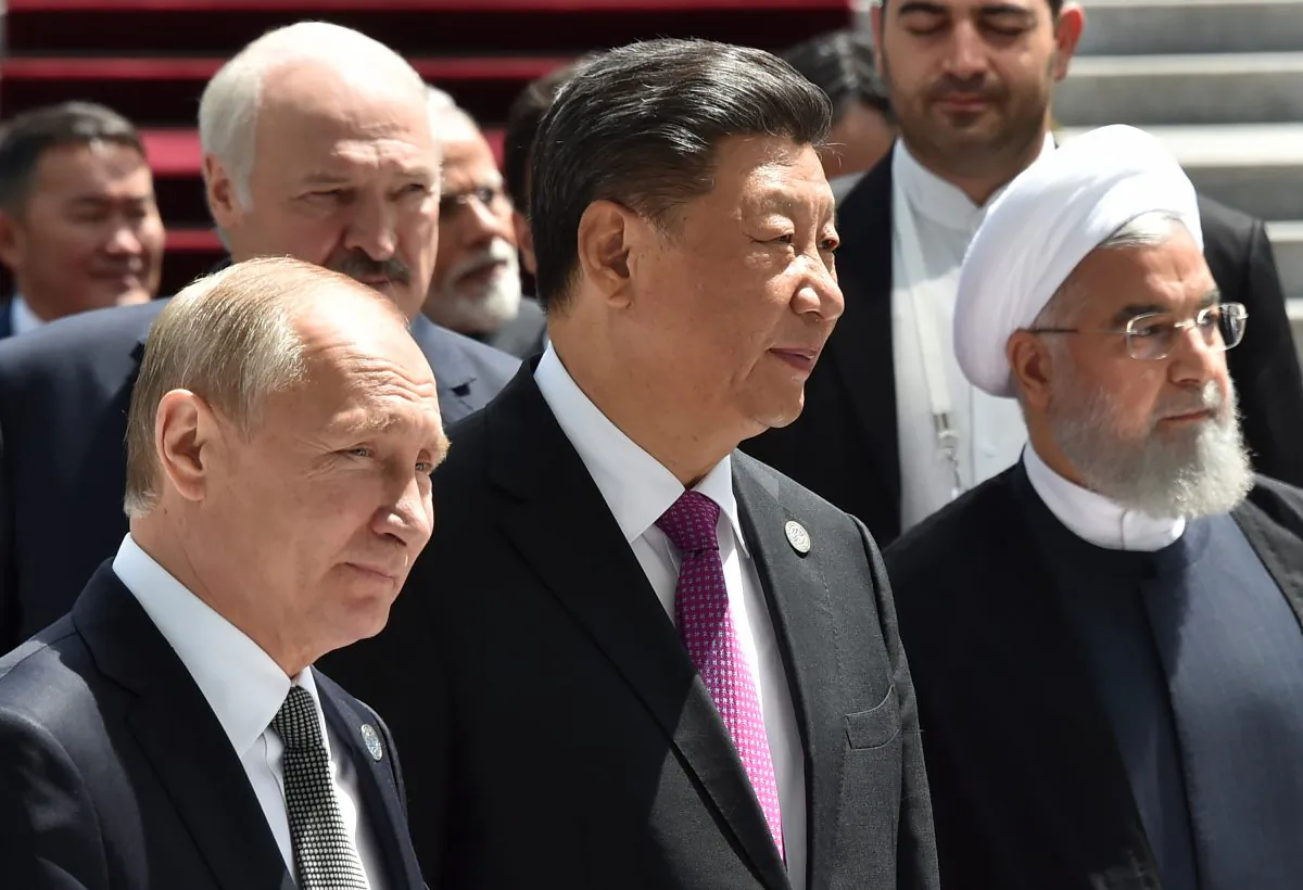 Russian President Vladimir Putin, Chinese leader Xi Jinping and Iran's President Hassan Rouhani walk as they attend a meeting of the Shanghai Cooperation Organisation (SCO) Council of Heads of State in Bishkek on June 14, 2019. (Vyacheslav Oseledko/AFP/Getty Images)