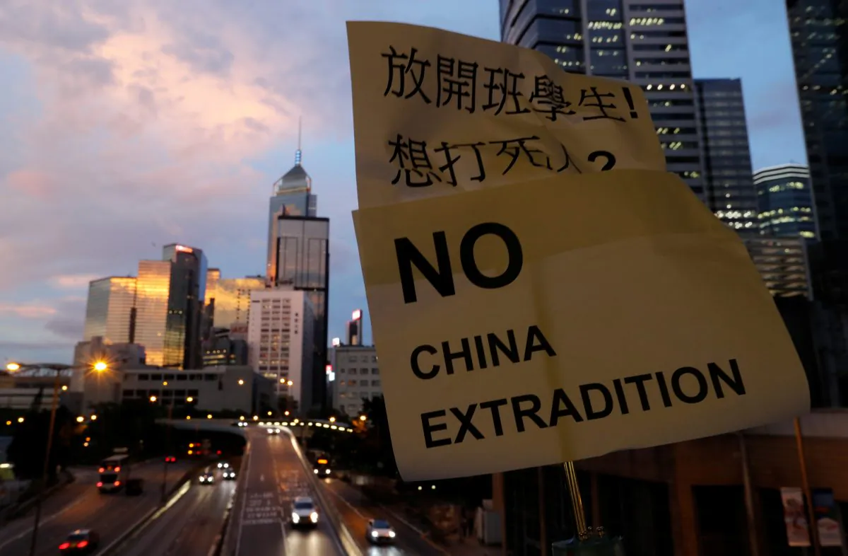 A placard is displayed during a protest following a day of violence over a proposed extradition bill, near the Legislative Council building in Hong Kong, China on June 13, 2019. (Jorge Silva/Reuters)