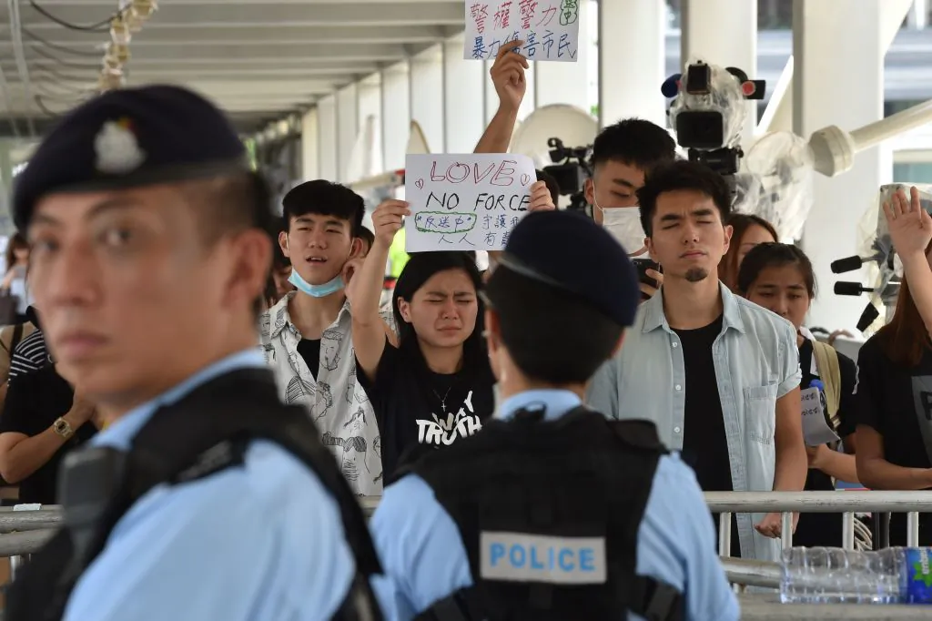 Police stand guard as protesters display placards during a demonstration against a proposed  extradition bill near the government headquarters in Hong Kong on June 14, 2019. (Hector Retamal/AFP/Getty Images)