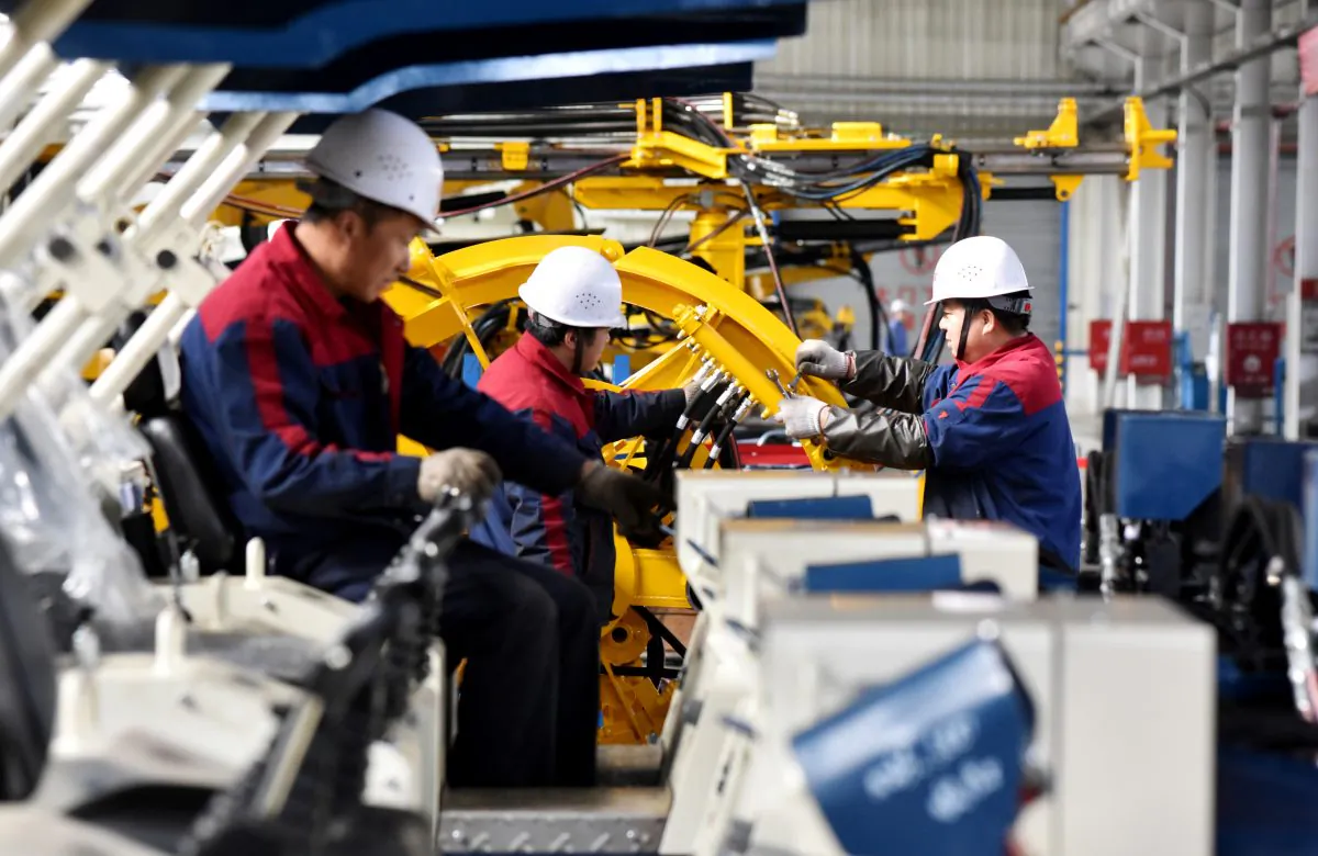 Employees work on a drilling machine production line at a factory in Zhangjiakou, Hebei Province, China on Nov. 14, 2018. (Reuters)