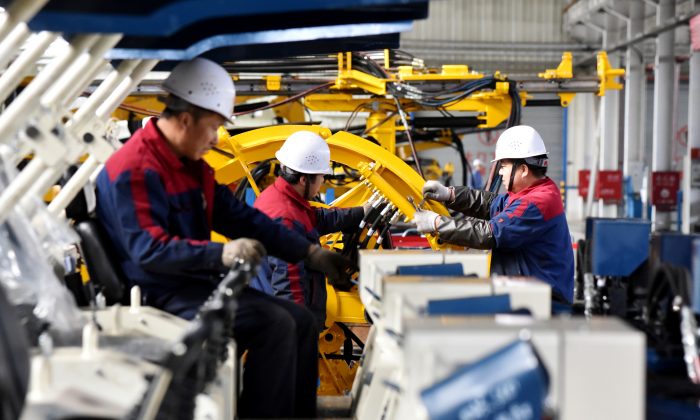 Employees work on a drilling machine production line at a factory in Zhangjiakou, Hebei Province, China on Nov. 14, 2018. (Reuters)