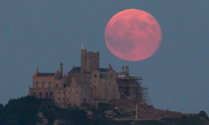 A full moon rises behind St Michael's Mount in Marazion near Penzance in Cornwall, England on June 28, 2018. (Matt Cardy/Getty Images)