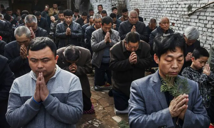 Chinese Catholic worshippers kneel and pray during Palm Sunday Mass during the Easter Holy Week at an underground church on April 9, 2017. (Kevin Frayer/Getty Images)