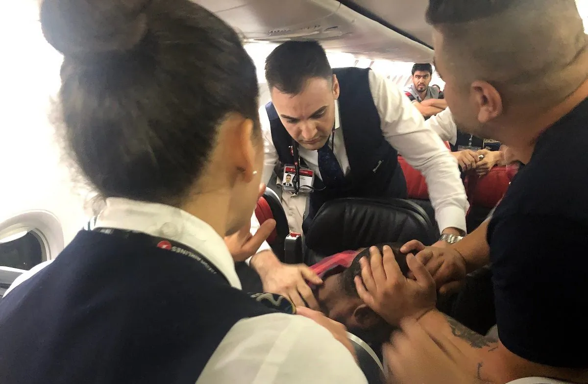The scene as Associated Press photographer Hussein Malla observes as passengers and crew aboard a Turkish Airlines jetliner subdue a man who started screaming a few minutes after takeoff from Istanbul. Turkey, on June 14, 2019.  (Hussein Malla/AP Photo)