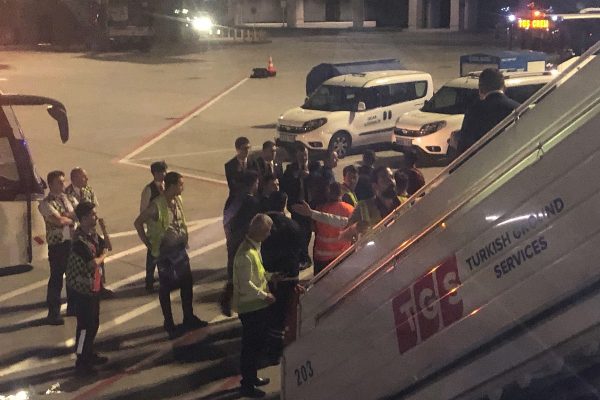 The scene observed by Associated Press photographer Hussein Malla as security, police and and officials remove a passenger