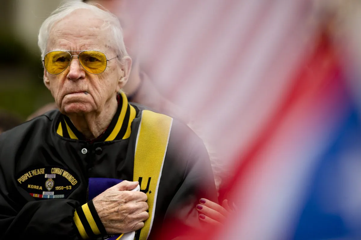 Bob Fulmer covers his heart during a prayer at the Korean War Memorial on Veterans Day, Wednesday, Nov. 11, 2015, in Philadelphia. (AP Photo/Matt Rourke)