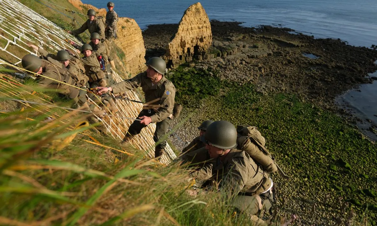 U.S. Army Rangers dressed in the uniforms of U.S. Army Rangers from World War II scale the cliffs of La Pointe du Hoc in a re-enactment of the D-Day assault on June 05, 2019 near Cricqueville-en-Bessin, France. Sean Gallup/Getty Images