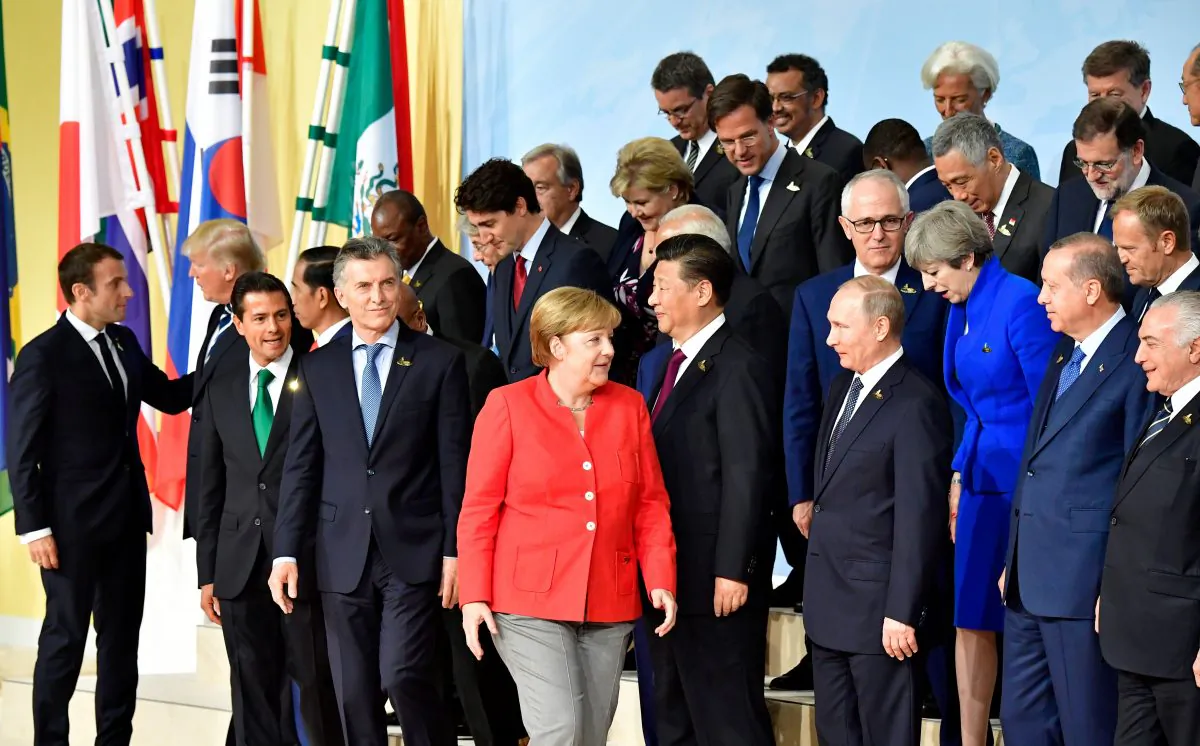 (1st row L-R) French President Emmanuel Macron greets US President Donald Trump as Indonesia's President Joko Widodo, Mexico's President Enrique Pena Nieto, German Chancellor Angela Merkel, China's President Xi Jinping, Russia's President Vladimir Putin, Britain's Prime Minister Theresa May, Turkey's President Recep Tayyip Erdogan line up for a family photo of the participants of the G20 summit in Hamburg, northern Germany on July 7, 2017.
TOBIAS SCHWARZ/AFP/Getty Images
