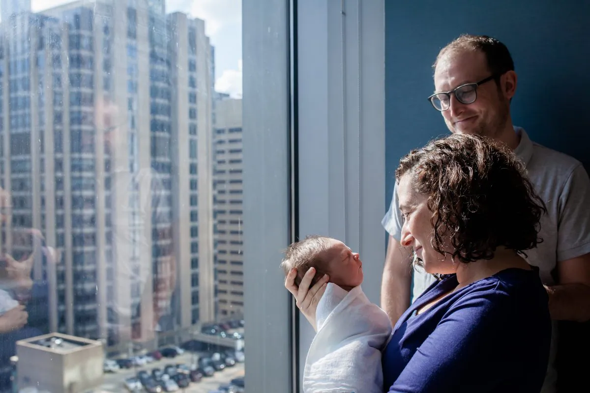 Reporter Jenny Gold and her husband, Alex Gourse, with their newborn son at Prentice Women’s Hospital in Chicago two days after his birth. (Courtesy of Baby Bella Photography)
