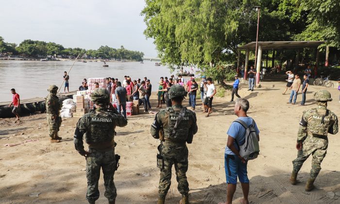 Naval police officers patrol the banks of the Suchiate river on the Mexico–Guatemala border in Ciudad Hidalgo, Chiapas State, Mexico, on June 17, 2019. (Quetzalli Blanco/AFP/Getty Images)